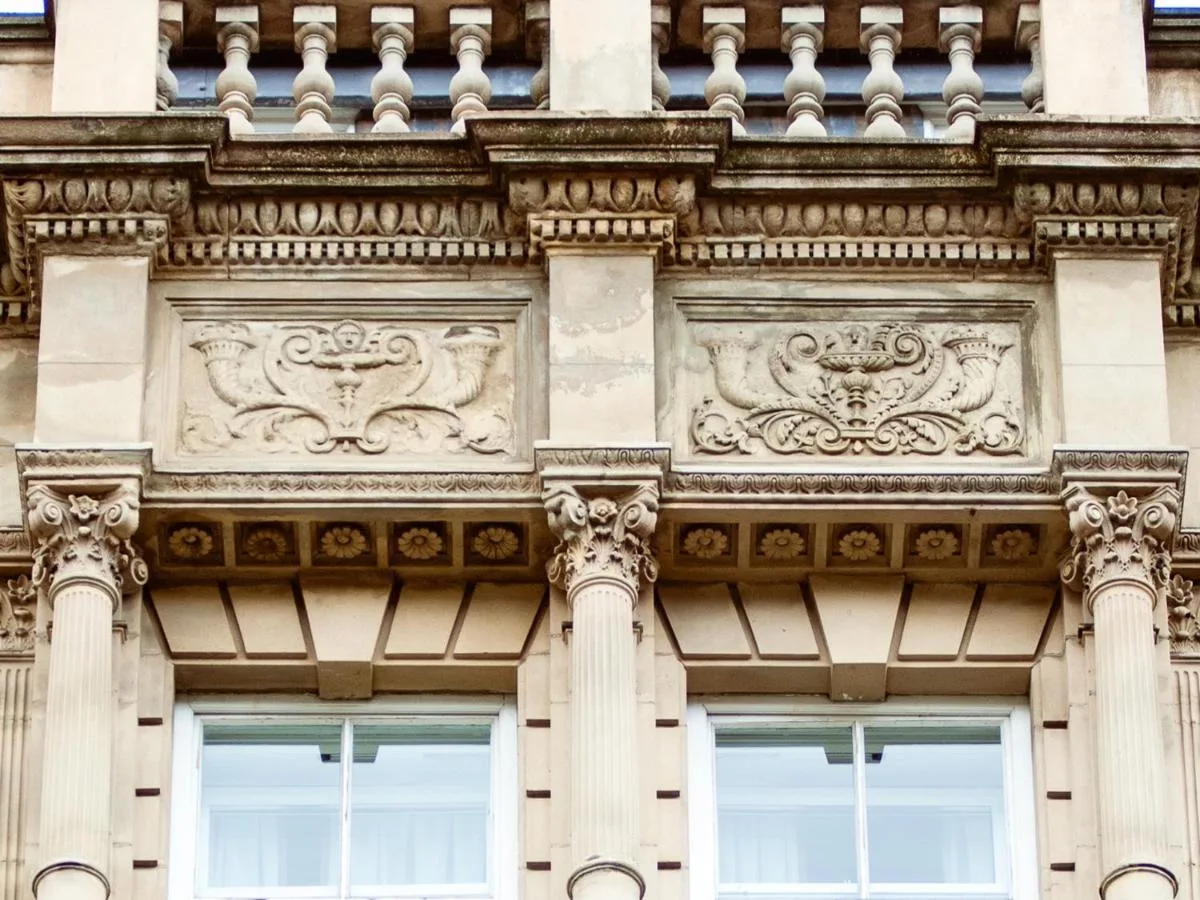 a building with a carving on the side of it at Grey Street Hotel in Newcastle upon Tyne